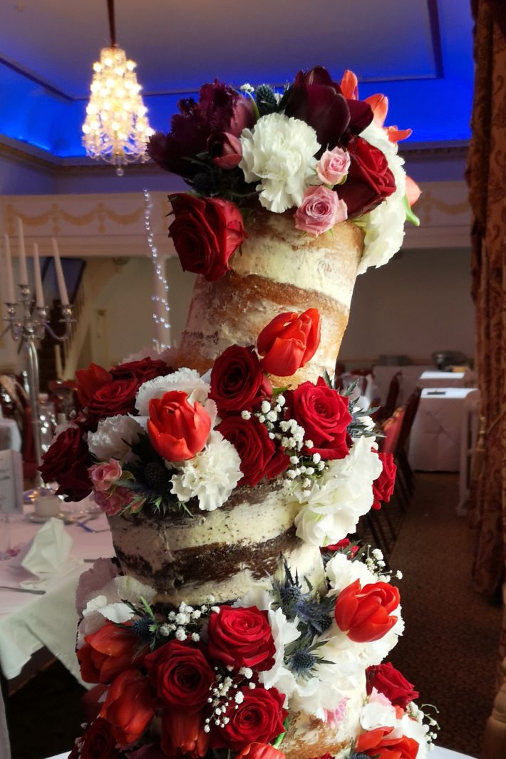 red wonky semi-naked wedding cake